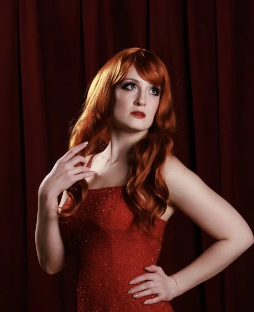 Redheaded performer in a sparkling red gown
