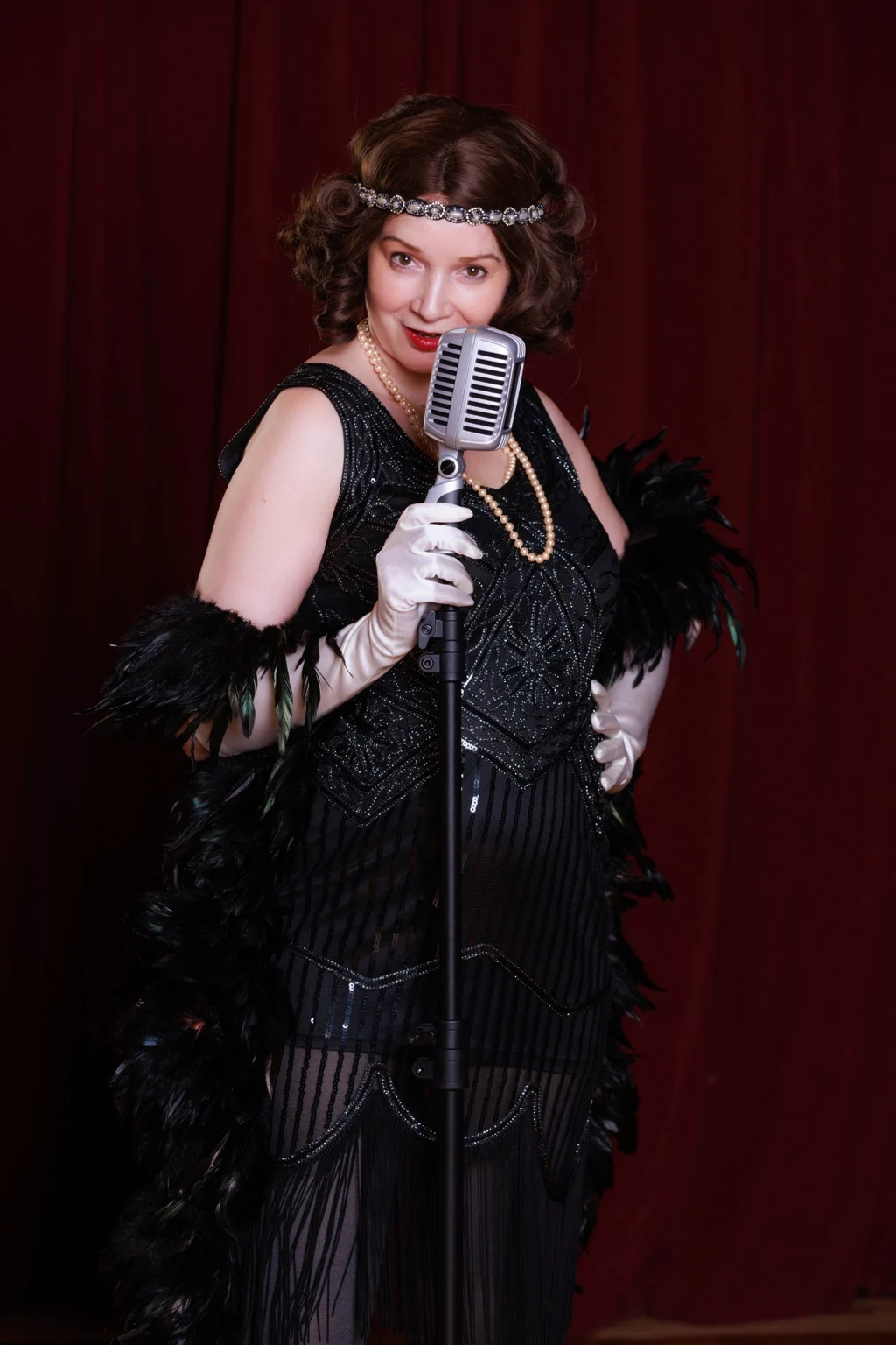 Vintage cabaret singer with feather boa and microphone